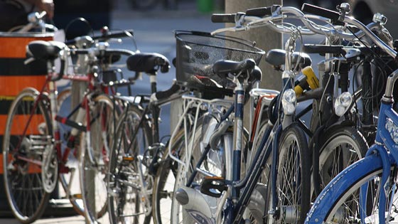 Image of bicycles stacked against bike racks 