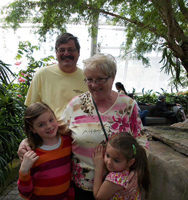 Image of Gary and Anne Marie Pieterse with grandkids.