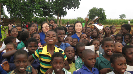 Jeon and a nursing colleague with school children in Malawi