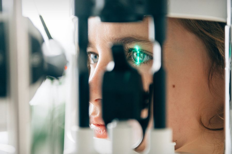 Woman looking through a phoropter