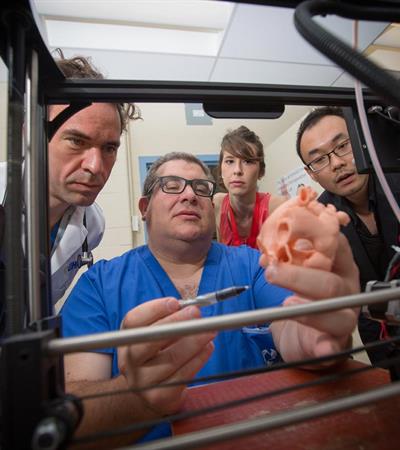 Dr. Eric Horlick, centre, holds the model of Kenneth Kubiak’s heart and Dr. Max Meineri far left 