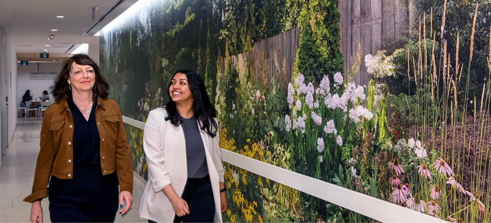 two people walking down a hospital hallway