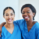 two health employees smiling