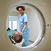radiologist preparing patient for CAT scan