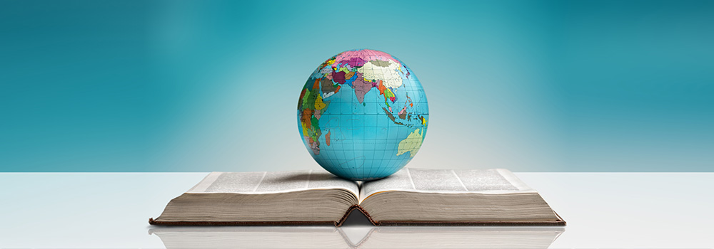 globe of earth sitting on an open book