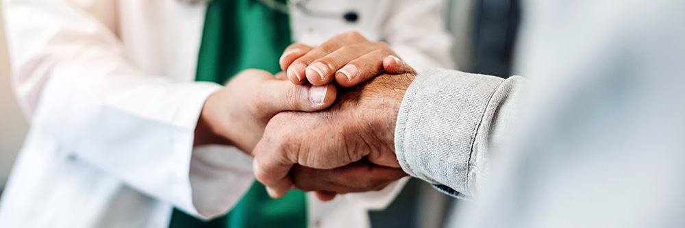 health professional holding a patient's hand