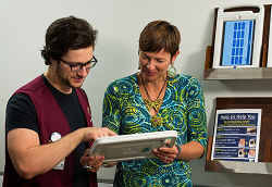DART volunteer showing iPad to female patient