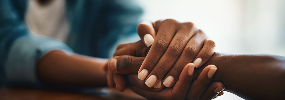 Banner image, 2 peoples hands holding