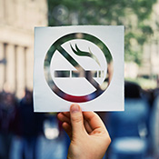 person holding up an anti-smoking sign