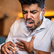 person smoking and coughing