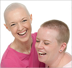 Two women with short hair laughing together