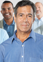 Middle-aged man in collared shirt wtih other men in background