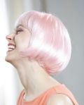 Female cancer survivor wearing synthetic pink wig