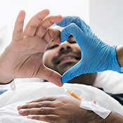 patient and health professional make a heart symbol with hands