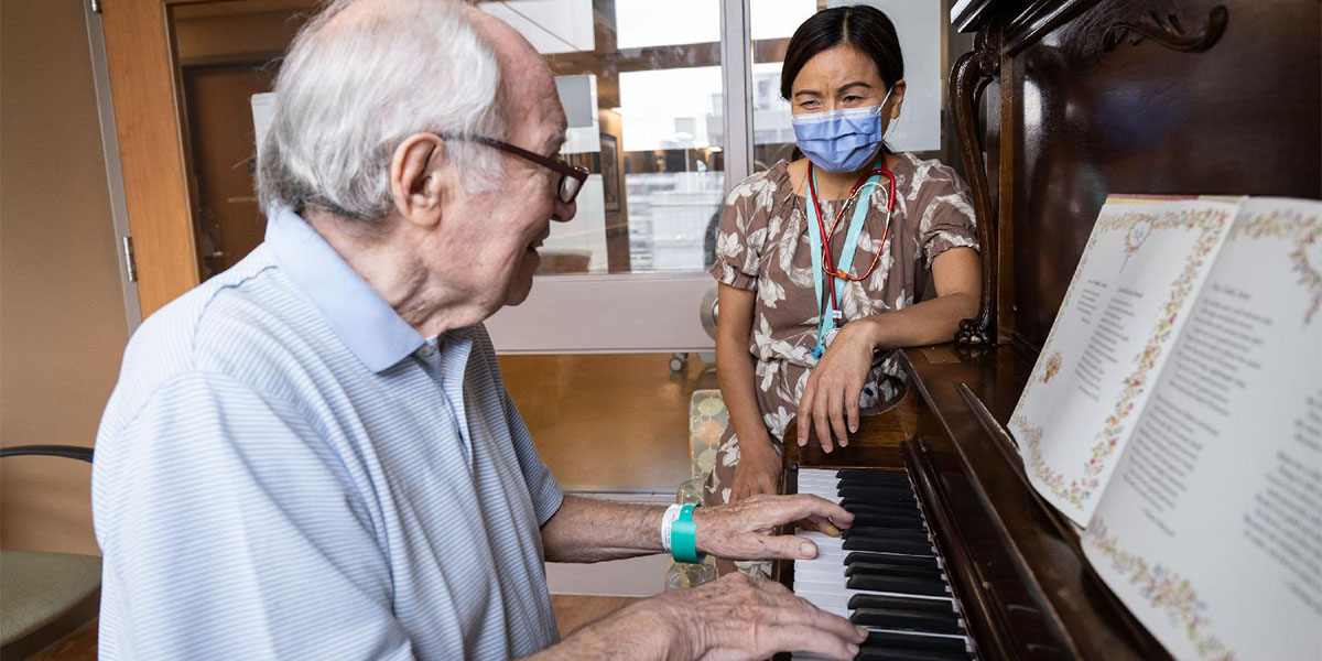Patient playing the piano for UHN staff