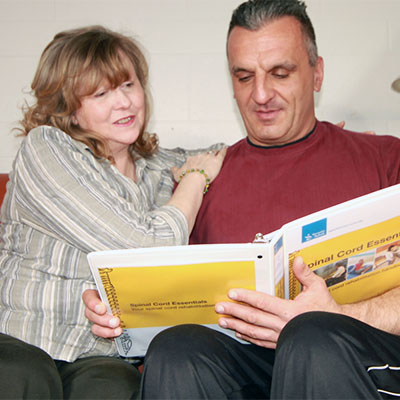 Man and woman reading the SCE binder
