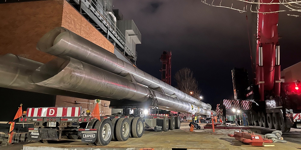The new 150-foot exhaust stack arrives on site