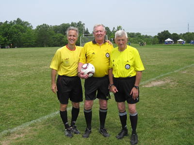 Robert Davidson (centre) and fellow referees volunteer at a soccer tournament for cystic fibrosis