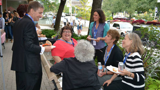 Image of Dr. Peter Pisters talking to staff at Toronto Rehab barbecue.