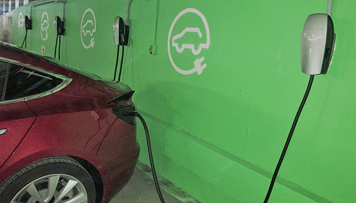 Car plugged into wall charging unit 