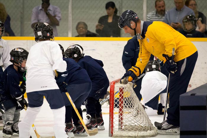 Cody play hockey with kids