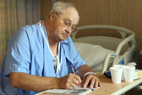 Patient sitting and writing something 