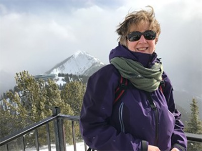 Judy in front of mountain peak 