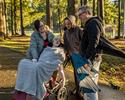 Family in park with child in wheelchair 