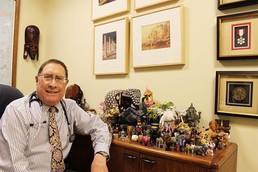 Jay Keystone at his desk with elephants 