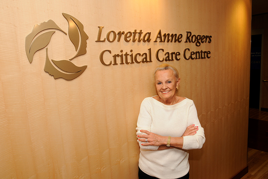 Loretta Rogers in front of clinic sign 