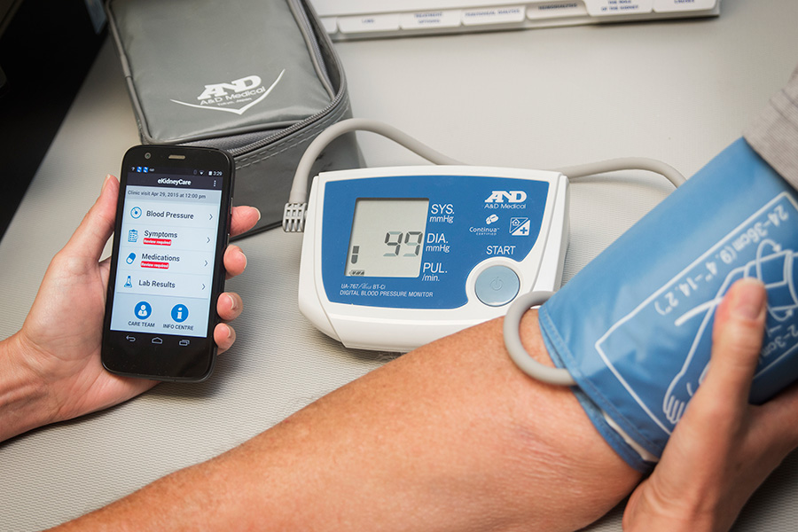 Shot of phone app and blood pressure gauge 