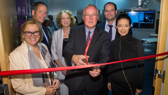 Image of UHN doctors and leaders cut the ribbon to mark the opening of two new treatment rooms