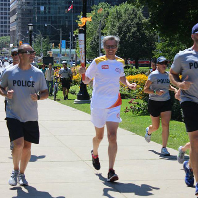 Gaetan running with the Pan Am torch