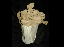 Paper towel arrangement in small white cup 