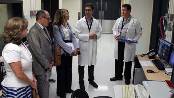 Image of Two UHN doctors in lab coats, Deputy Minister and CAHO staff 