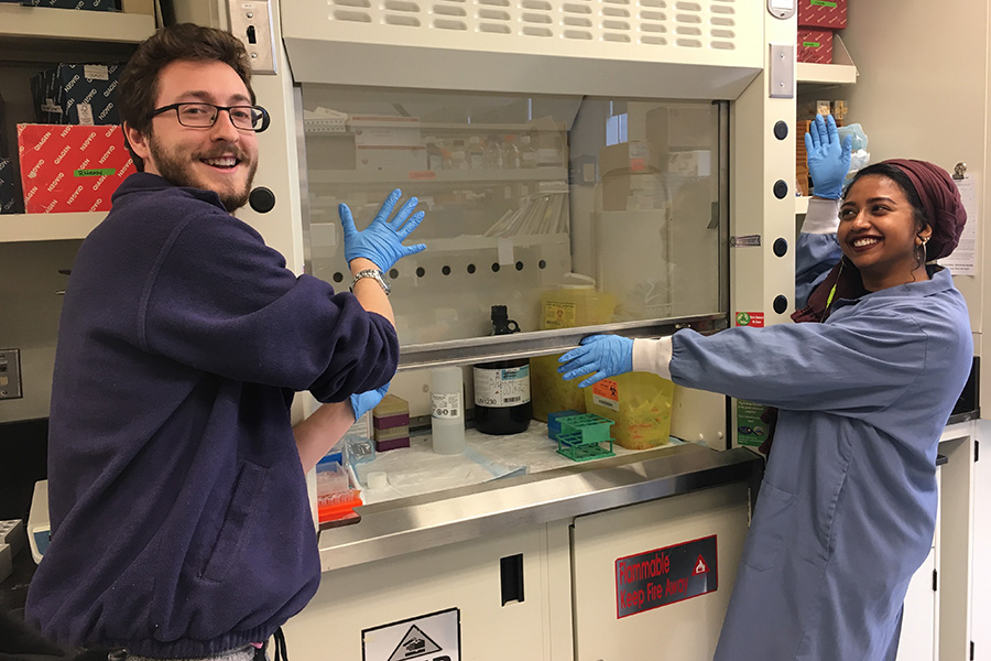 2 smiling people in lab 