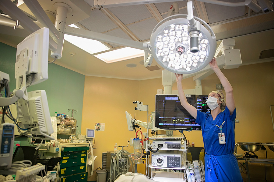Nurse adjusting lights in the OR 