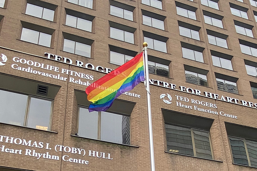 Pride flag against backdrop of UHN buildings 