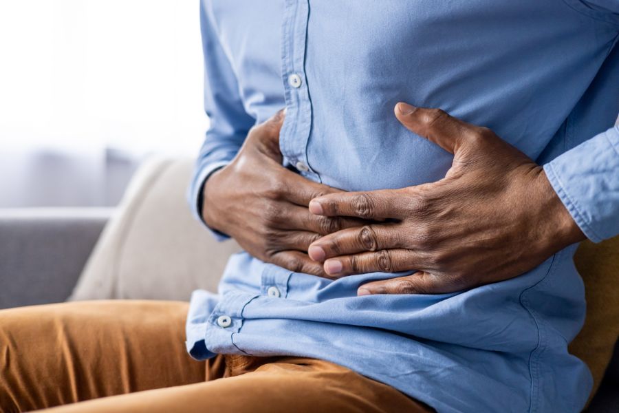 A man holding his stomach with both hands