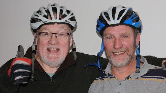 Two guys in cycling helmets 