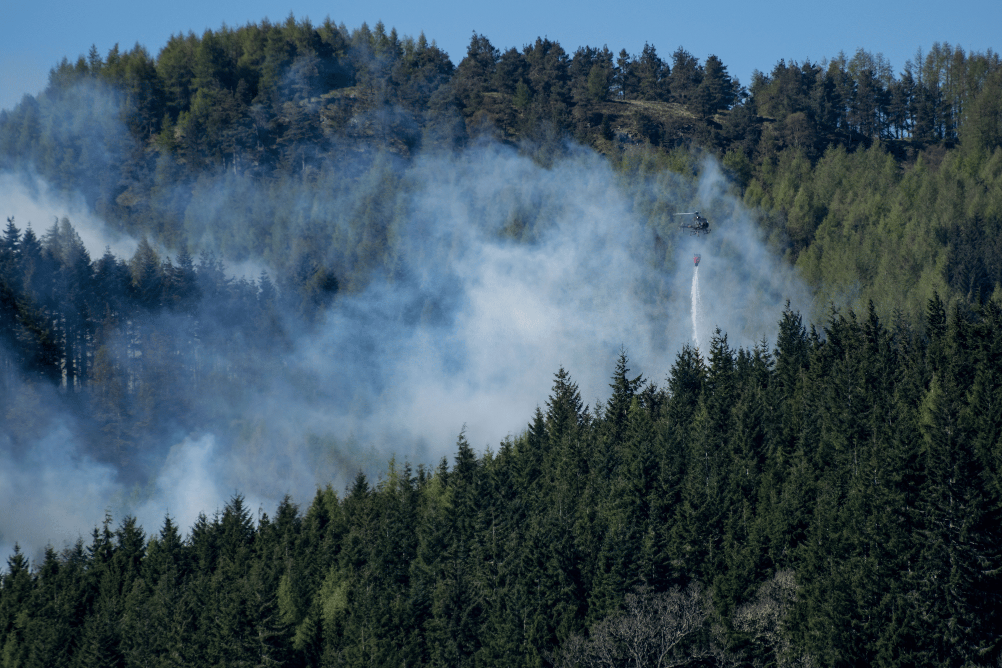Helicopter flying over wildfire