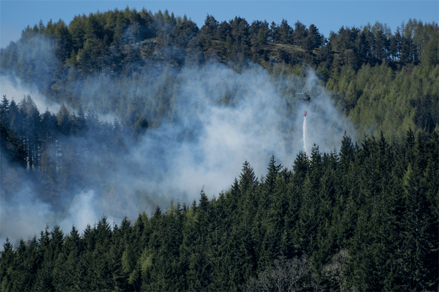 Helicopter flying over wildfire