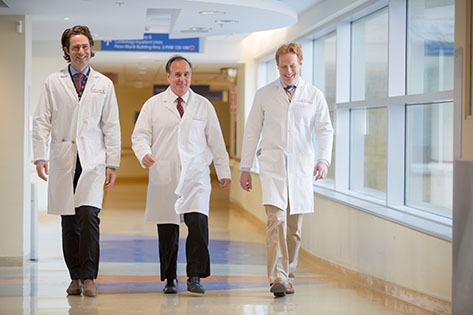 Dr. Patrick Lawler, Dr. Michael Farkouh and Dr. Jacob Udell walking in the hall