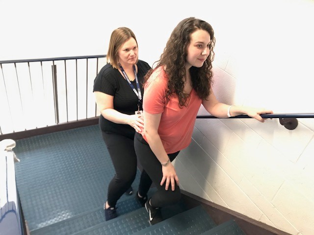 Patient and caregiver on stairs