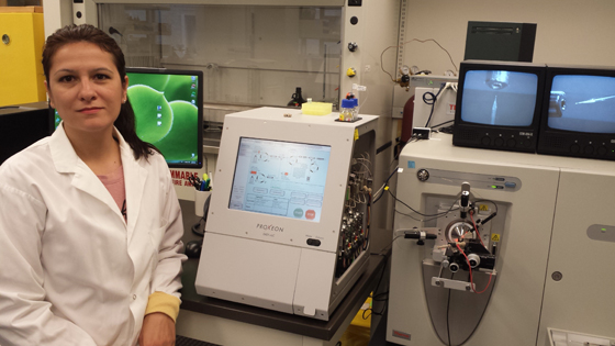 Image of Dr. Andrea Bozovic and a mass spectrometer 