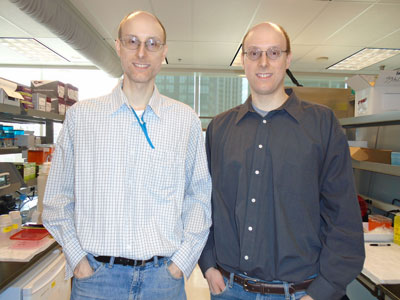 Image of the Winer twins standing in their lab 