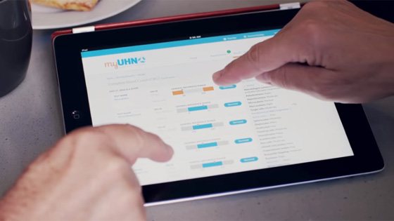 two fingers pointing at patient portal on tablet 