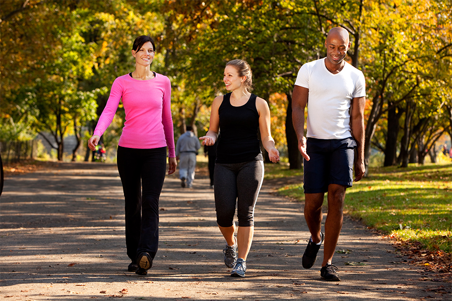 Three people walking in the park