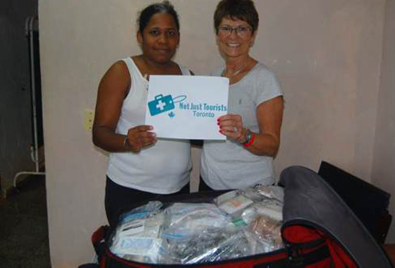 Two staff members showcase medical supplies.