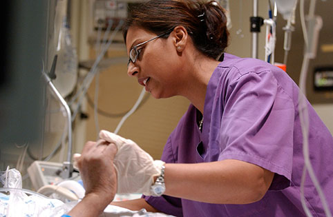 Image of nurse holding patient's hand